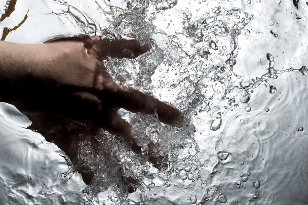 Hand on the black water - Photo, Image