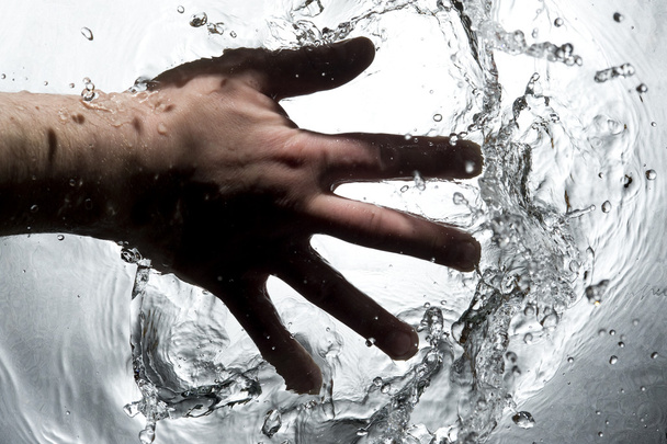 Hand on the black water - Photo, Image