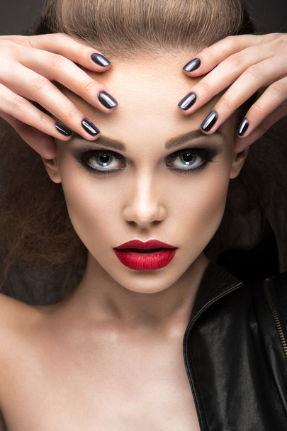 Beautiful girl in leather jacket with bright makeup and manicure "Cat's Eye". Beauty face. Nail Design. - Фото, изображение