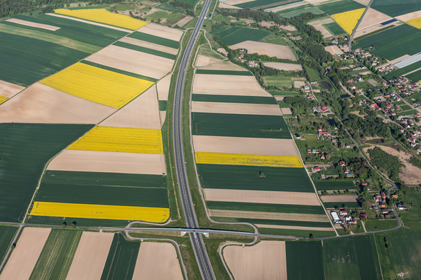 aerial view of highway and green harvest fields - 写真・画像