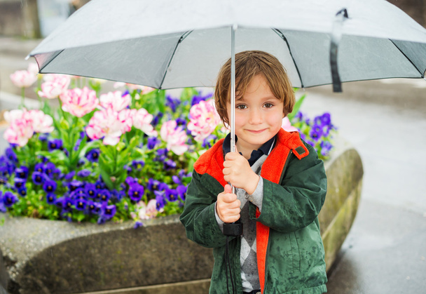 Ulkona muotokuva suloinen pieni blondi poika sateenvarjo sateen alla
 - Valokuva, kuva