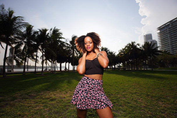 Trendy young Jamaican woman in the park - Фото, изображение