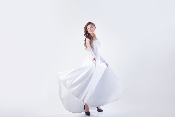 Beautiful bride in wedding dress, white background, horizontal - Photo, image