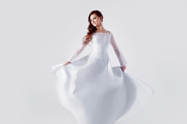 Beautiful bride in wedding dress, white background - Photo, image