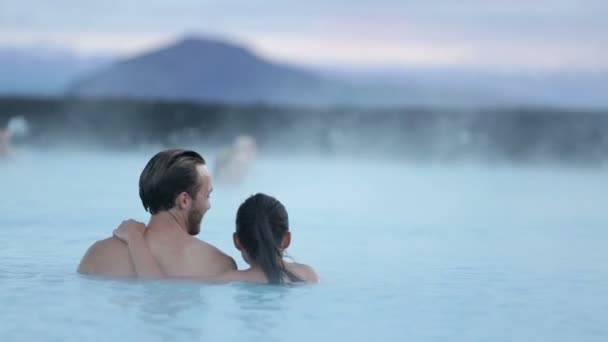 Couple relaxing in hot pool on Iceland - Кадры, видео