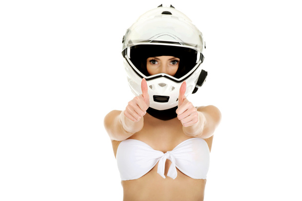 Woman in motorcycle helmet with thumbs up. - Foto, afbeelding