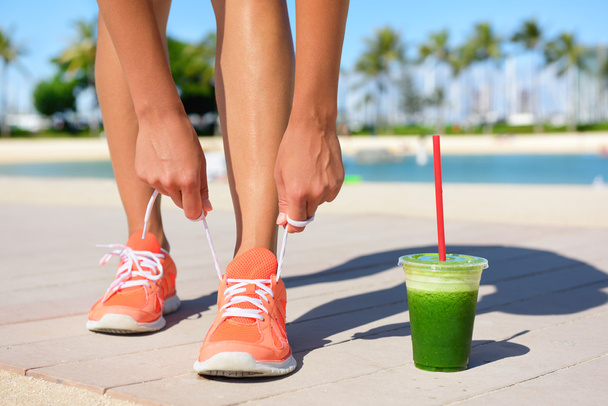 Woman runner with green vegetable smoothie - Фото, изображение