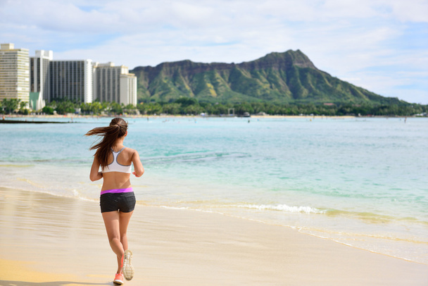 Woman running jogging on beach - 写真・画像