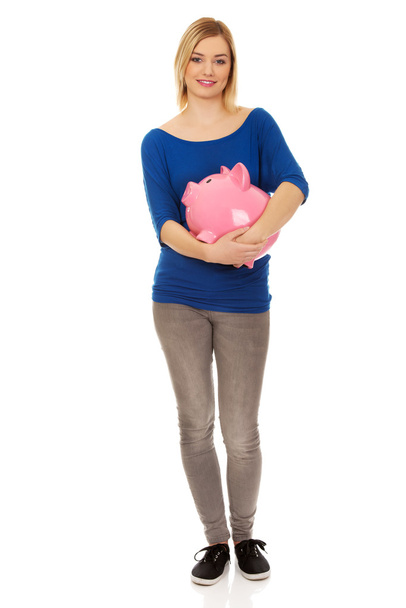 Happy woman holding piggybank. - Fotografie, Obrázek