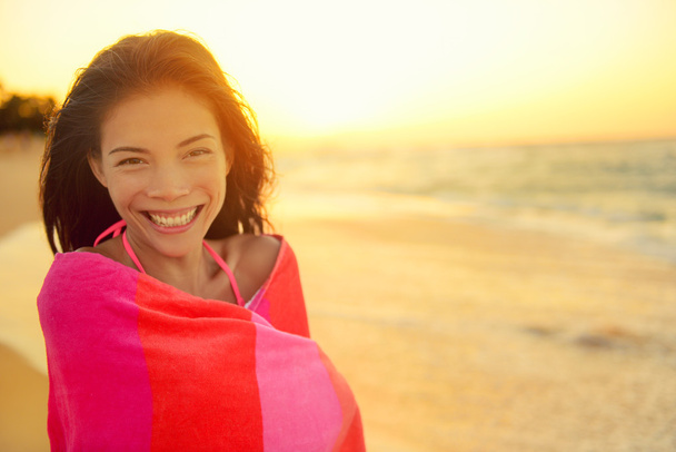 Asian woman wrapped in towel at beach - Фото, зображення