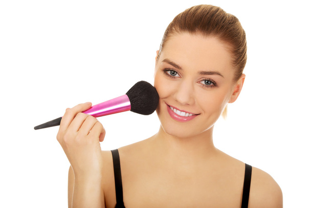 Woman applying make up. - Fotó, kép