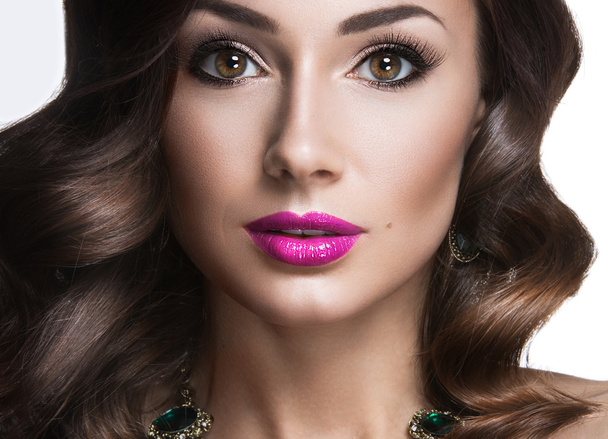Beautiful woman with evening make-up, pink lips and curls. Beauty face. - Photo, Image