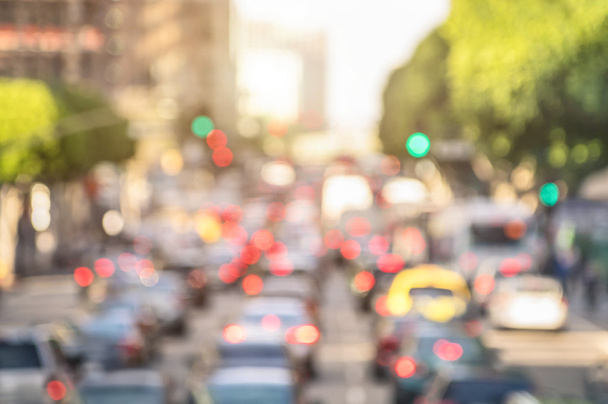 Rush hour with defocused cars and generic vehicles - Traffic jam in Los Angeles downtown - Blurred bokeh postcard of american iconic city with bright daylight colors - Real life transportation concept - Photo, Image