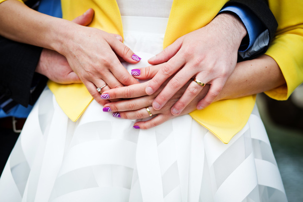Newly wed couple embracing - focus on hands with wedding rings - Photo, Image