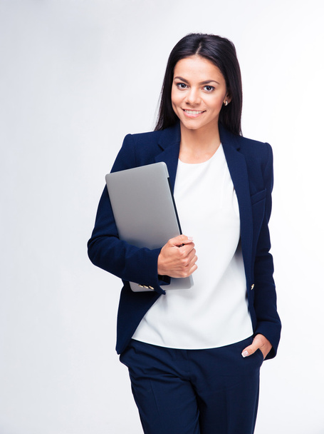 Cheerful businesswoman standing with laptop - Фото, зображення
