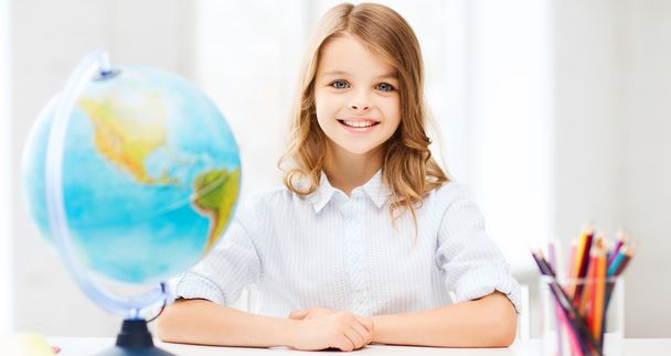 student girl with globe at school - Foto, Imagen