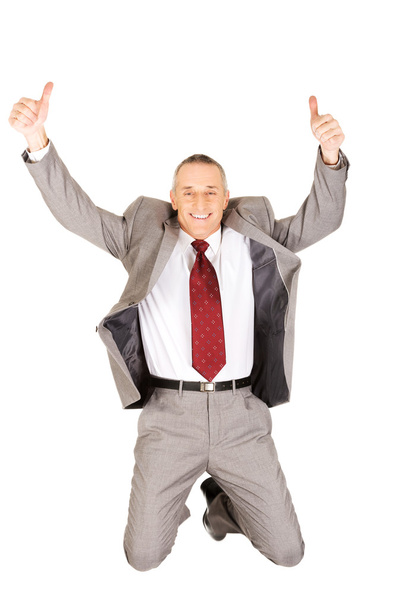 Excited businessman jumping with ok sign - Foto, imagen