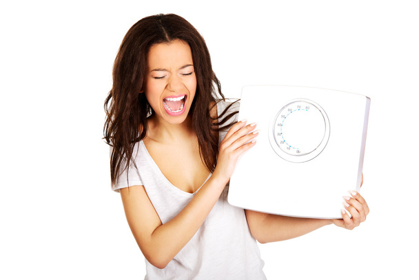 Angry woman holding a scale. - Photo, Image