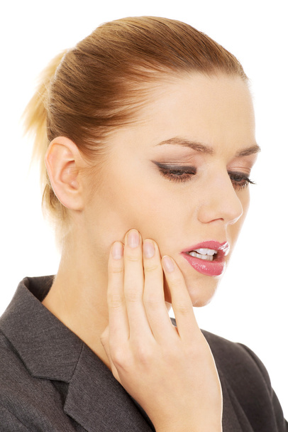 Businesswoman with tooth ache. - 写真・画像