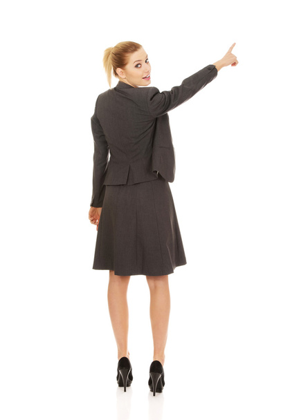 Businesswoman pointing up. - Zdjęcie, obraz