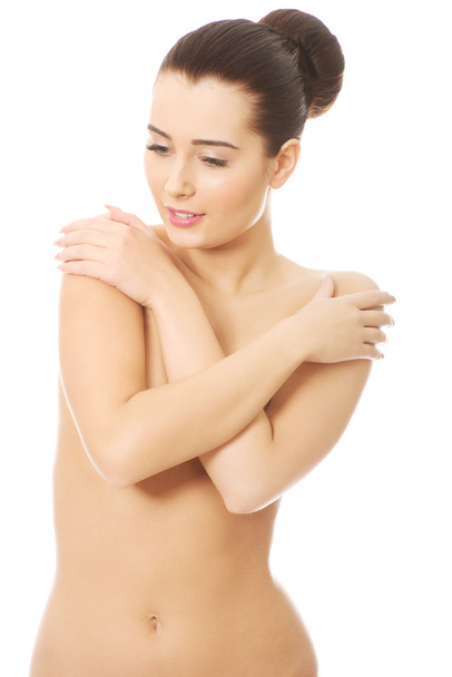 Slim woman covering her breast. - Фото, изображение