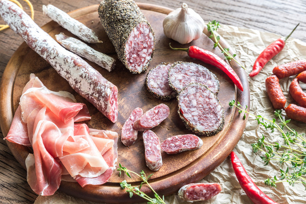 Different kinds of sausage on the wooden background - Photo, Image