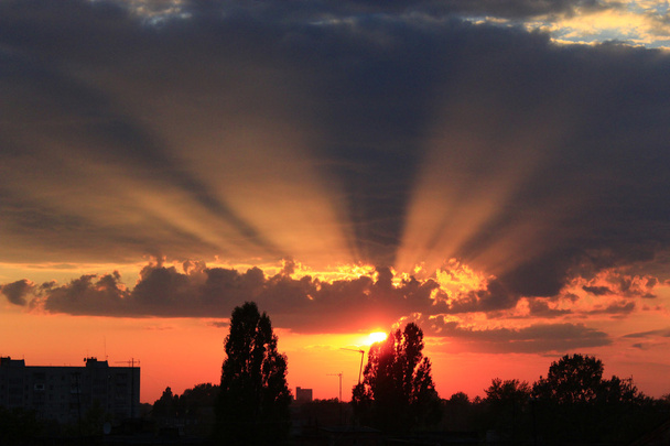 літній захід сонця з темним небом і сонячними променями
 - Фото, зображення