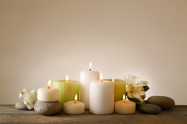 Beautiful composition with candles and spa stones on light background - Fotografie, Obrázek