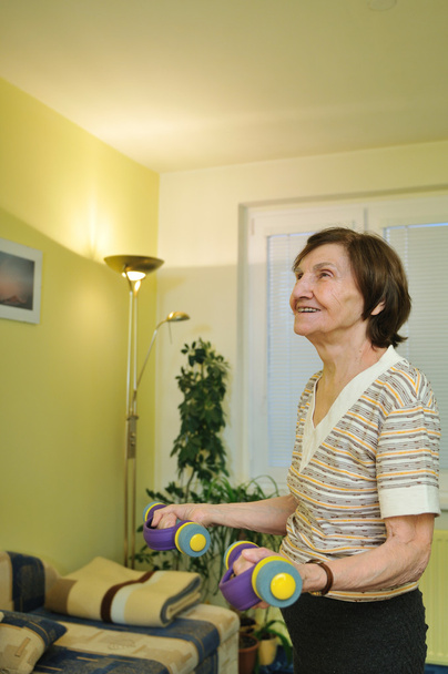 Mature woman exercises at home - Foto, Bild
