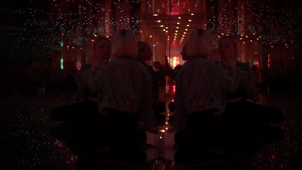 Young Blond Woman Exploring Room of Mirrors in Dreamlike Fantasy Neon Light - Footage, Video