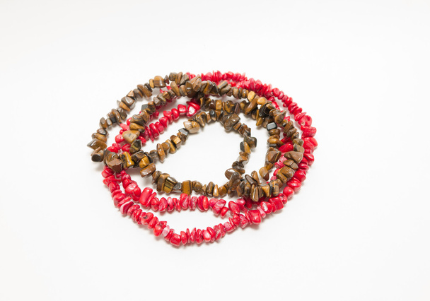 Natural gem red corals and yellow tiger eye stones stylish necklaces isolated on white - Fotografie, Obrázek