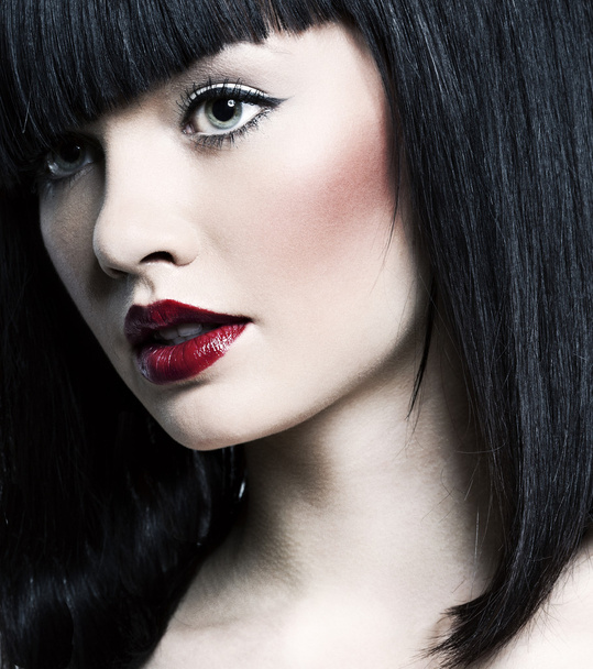Beautiful girl with perfect skin, red lipstick and black hair on white back - Фото, зображення