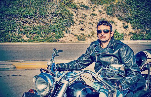 biker and his motorcycle in retro tone - Photo, Image