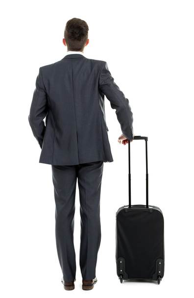 Man holding suitcase isolated on white - Photo, image