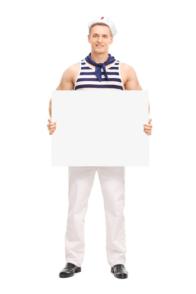 Handsome sailor holding a blank banner - Foto, Imagen