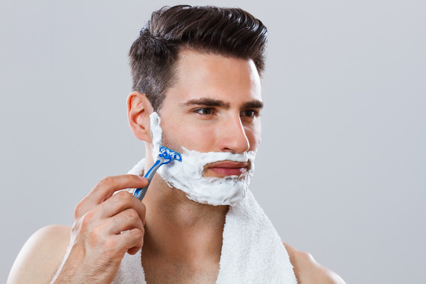 Photo of handsome man shaving his face - Zdjęcie, obraz