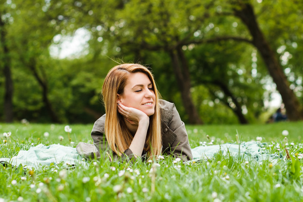 Girl enjoys lying down in nature - Photo, Image