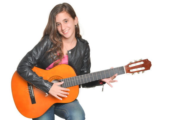 Trendy hispanic teenage girl playing an acoustic guitar - Valokuva, kuva