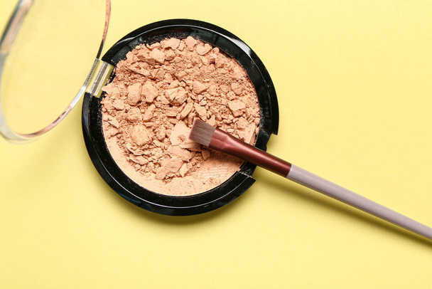 Makeup brush and facial powder on yellow background - Photo, Image