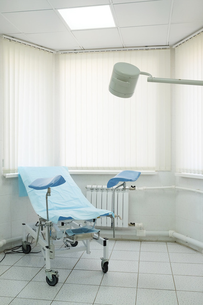 Gynecological chair in room - Fotoğraf, Görsel