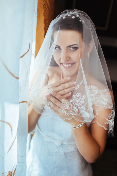 Bride getting ready. beautiful bride in white wedding dress with hairstyle and bright makeup. Happy sexy girl waiting for groom. Romantic lady in bridal dress have final preparation for wedding - Φωτογραφία, εικόνα
