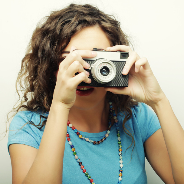 νεαρή γυναίκα σγουρά με εκλεκτής ποιότητας φωτογραφική μηχανή - Φωτογραφία, εικόνα