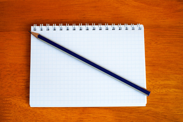 pencil on a notebook - Фото, изображение