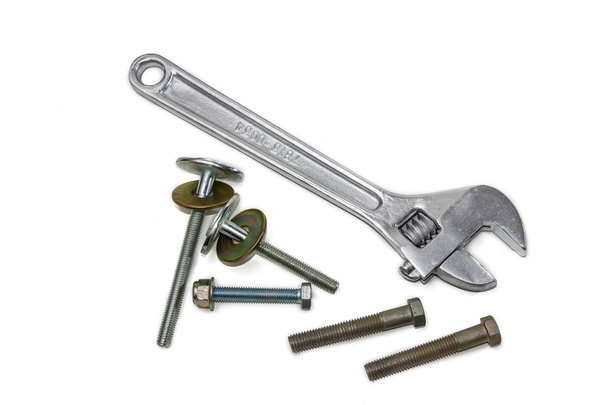 Регулируемый гаечный ключ и болты
 - Фото, изображение