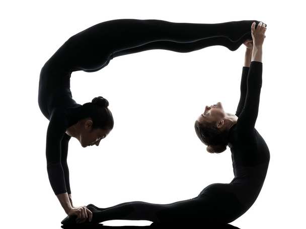 two women contortionist  exercising gymnastic yoga silhouette - Fotoğraf, Görsel