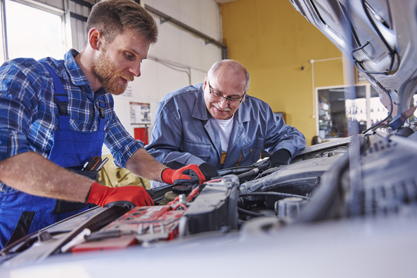mechanics in car workshop - Фото, изображение