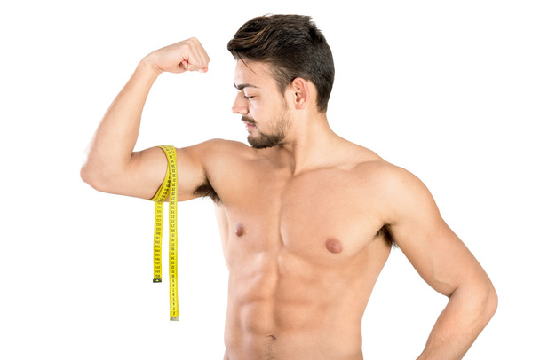 Handsome and fit man with measuring tape - Fotoğraf, Görsel