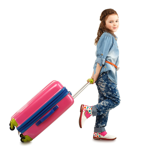 Full-length portrait of a pretty little girl with big pink suitc - Fotó, kép