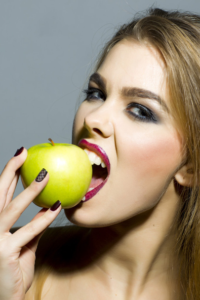 Passionate blonde girl with apple - Foto, Imagen