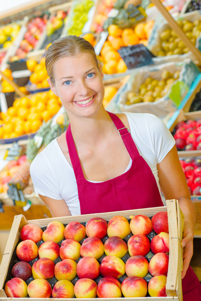 Woman holding a crate of fruit - Foto, Bild